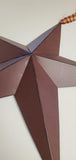 Burgundy metal barn star wall hanging with homespun plaid hanger.
