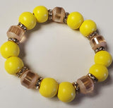 Bracelet with yellow and brown beads on a white background