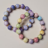 Set of pastel beaded bracelets on a light background