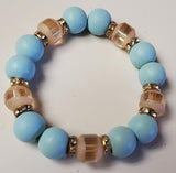 Bracelet with blue beads and gold accents on a white background
